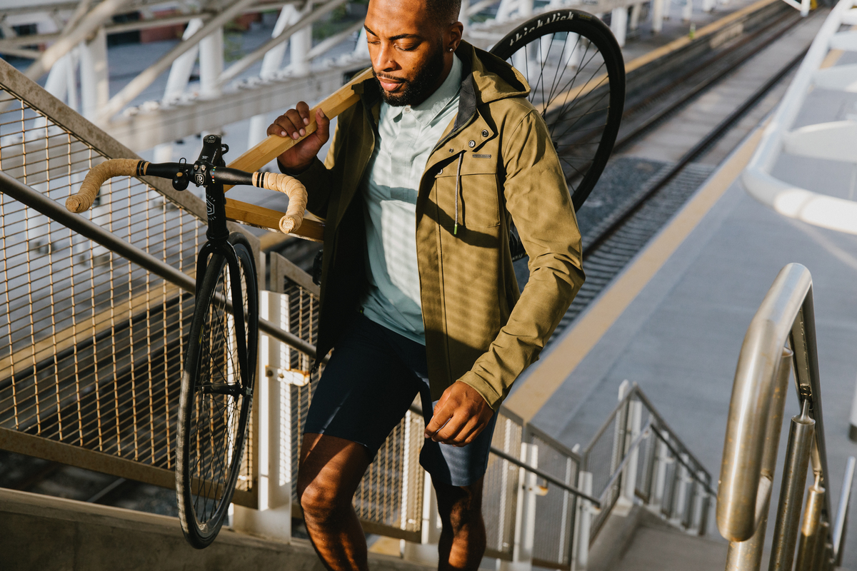 Casual Cyclist Carrying Bike In Urban Area